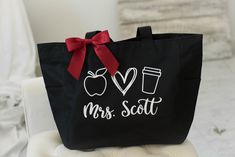 a black tote bag that says i love mrs scott with an apple on it