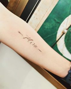 a woman's arm with the word love written in cursive writing on it