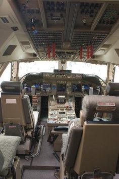 the inside of an airplane cockpit with several seats and electronic equipment on it's sides