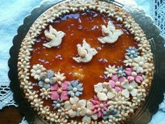 there is a cake decorated with shells and flowers on the top layer, sitting on a table