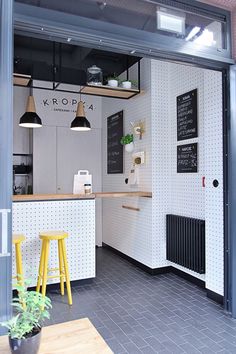 an open kitchen area with yellow stools