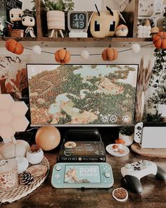 a computer screen sitting on top of a wooden desk next to other items and decorations