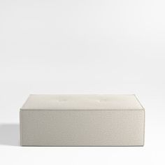 a white box sitting on top of a white floor next to a black object in the background