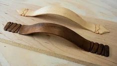 two pieces of wood sitting on top of a wooden table