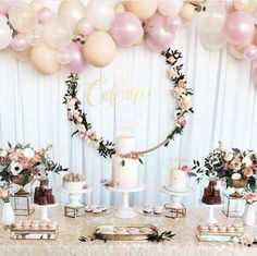 a table topped with lots of cake and balloons