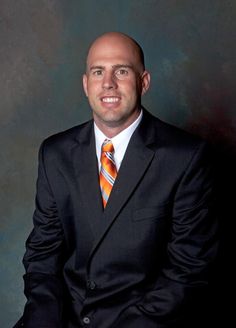 a man in a suit and tie posing for a photo