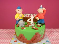 two figurines are sitting on top of a brick birthday cake with the number four