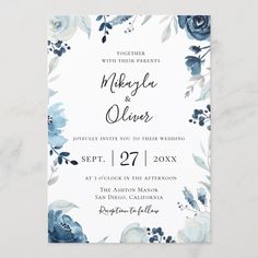 an elegant floral wedding card with blue flowers and leaves on the front, in black ink