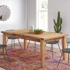 a wooden table sitting on top of a rug