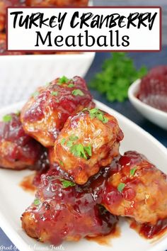 this is an image of turkey cranberry meatballs on a plate with sauce and parsley