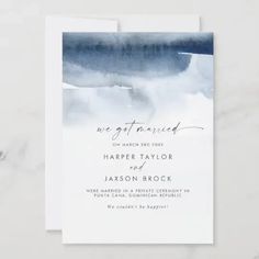 the green watercolor wedding card is displayed on a marble surface