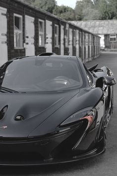 a black sports car parked in front of a building