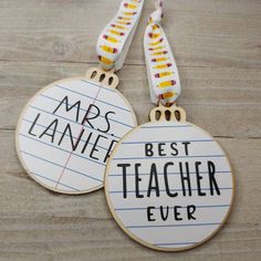 two wooden badges with writing on them that say, best teacher ever and mrs lanie