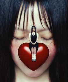 a woman sitting on top of a red heart with her eyes closed to the side