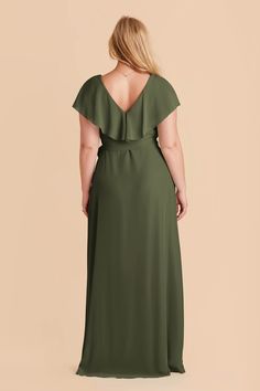 a woman in a green dress with her back to the camera