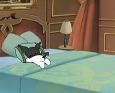 a cartoon cat laying on top of a bed in a bedroom next to a lamp