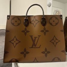 Louis Vuitton On The Go Tote MM Brown Monogram Reverse Leather Luxury Monogram Canvas Shoulder Bag, Luxury Monogram Canvas Tan Shoulder Bag, Luxury Tan Monogram Canvas Shoulder Bag, Luxury Bags With Designer Logo, Luxury Designer Logo Bags For Daily Use, Luxury Monogram Print Shoulder Bag For Daily Use, Brown Leather Shoulder Bag With Monogram Print, Leather Bags With Designer Logo For Shopping, Brown Monogram Print Bag For Daily Use