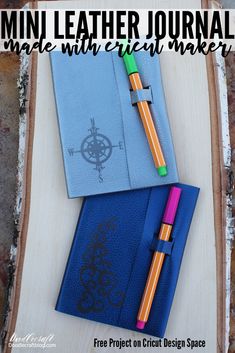 the mini leather journal is next to a pen and notebook on a piece of wood