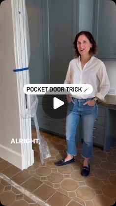 a woman standing in front of a door with her hands on her hips and looking at the camera