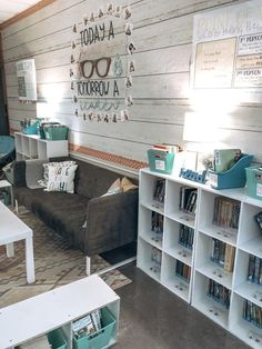 a living room filled with furniture and lots of books