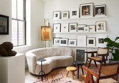 a living room filled with furniture and pictures on the wall