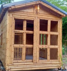 a small building made out of bamboo with lots of windows