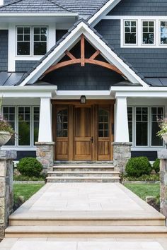 a house with stone steps leading up to the front door and entry way that leads into the home