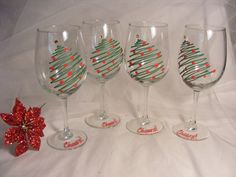 four wine glasses with christmas decorations on them