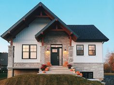 a house with pumpkins on the front lawn