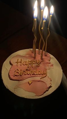 a birthday cake with lit candles on it