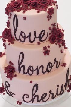 a three tiered cake decorated with flowers and the words love, honor & cherish