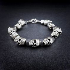 Silver Skull & Hematite Beaded Bracelet This Handmade Men’s Silver Skull Bracelet Combines One Of Humanity’s Oldest And Most Powerful Symbols With Contemporary Geometric Shaped Hematite. Details: Bracelet Features 12x10mm Silver Plated Skulls Interspersed With 6mm Hexagon Shaped Hematite Beads. Strung On Durable Stainless Steel And Secured With Lobster Clasp Closure. Measurements: 8 Inches In Length Including Clasp And 10mm At The Widest Point. (Also Available In Other Sizes, Please Inquire) Wei Silver Stainless Steel Beaded Bracelets, Silver Hematite Bracelets With Faceted Beads, Silver Hematite Bracelet With Faceted Beads, Silver Hand-strung Hematite Jewelry, Silver Hematite Hand-strung Jewelry, Adjustable Silver Skull Beaded Bracelets, Silver Skull Beaded Bracelets As Gift, Adjustable Silver Beaded Skull Bracelets, Motorcycle Chain Bracelet