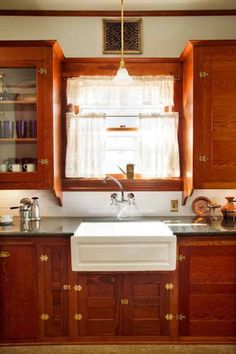 a kitchen with wooden cabinets and a white sink