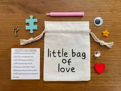 a little bag of love is on the table next to some magnets and a piece of puzzle