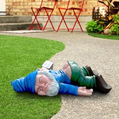 a statue of an old man laying on the ground