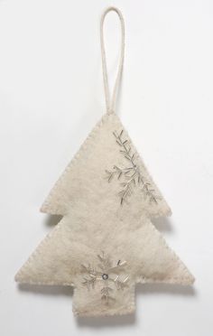 an ornament shaped like a christmas tree with snowflakes hanging from it