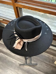 Discover the rugged charm of our Burned Western Hat. This unique, handcrafted cowboy hat features a distressed look, giving it a vintage, well-worn appeal perfect for Western enthusiasts and fashion-forward individuals. Features: Handcrafted Design: Each hat is meticulously burned and distressed to achieve a one-of-a-kind look. Premium Materials: Made from high-quality materials for durability and comfort. Unique Aesthetic: The burned finish adds a distinctive vintage style that sets it apart. B Bohemian Black Hat Band For Western-themed Events, Bohemian Black Hat For Western-themed Events, Country Style Distressed Wide Brim Hats, Black Rustic Adjustable Hat, Black Rustic Hat For Rodeo, Rustic Black Hat For Rodeo, Bohemian Black Hat Bands For Ranch, Black Bohemian Felt Hat For Western-themed Events, Bohemian Distressed Fedora Hat