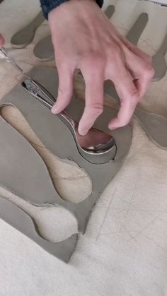 someone is cutting out the bottom part of a pair of shoes