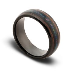 a wedding ring with an opal and wood inlays on the inside of it