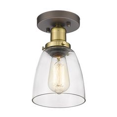 a light fixture with a clear glass shade on the bottom and an antique brass finish