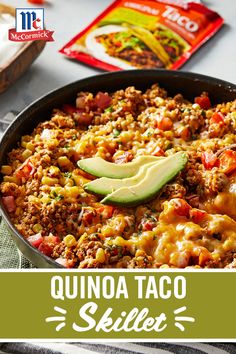 a skillet filled with quinoa taco skillet and topped with an avocado