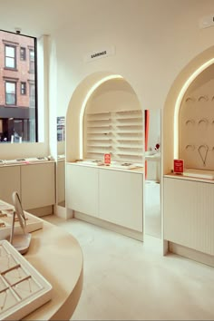 the interior of a jewelry store with white counter tops