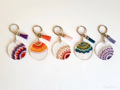 four different key chains with designs on them