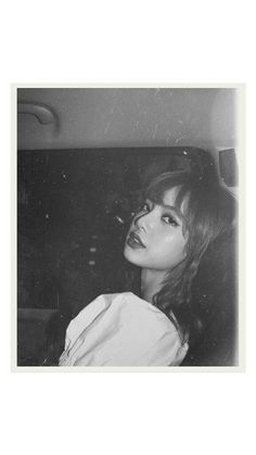 black and white photograph of a woman in a car looking off into the distance with her eyes closed