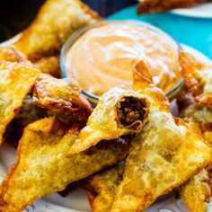 some fried food on a plate with dipping sauce