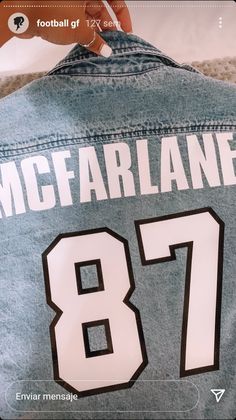 the back of a football jersey that says mcfarland 817 on it and someone's hand reaching out