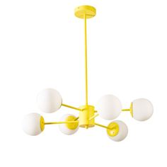 a yellow chandelier with five white balls hanging from it