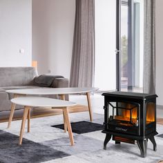 a living room with a couch, coffee table and fire place in the middle of it