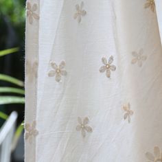 an embroidered curtain with flowers on it