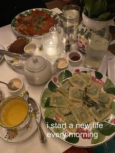 a table filled with plates and bowls of food next to cups, sauces and spoons